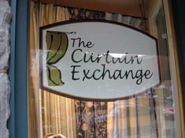 The Curtain Exchange logo and window sign